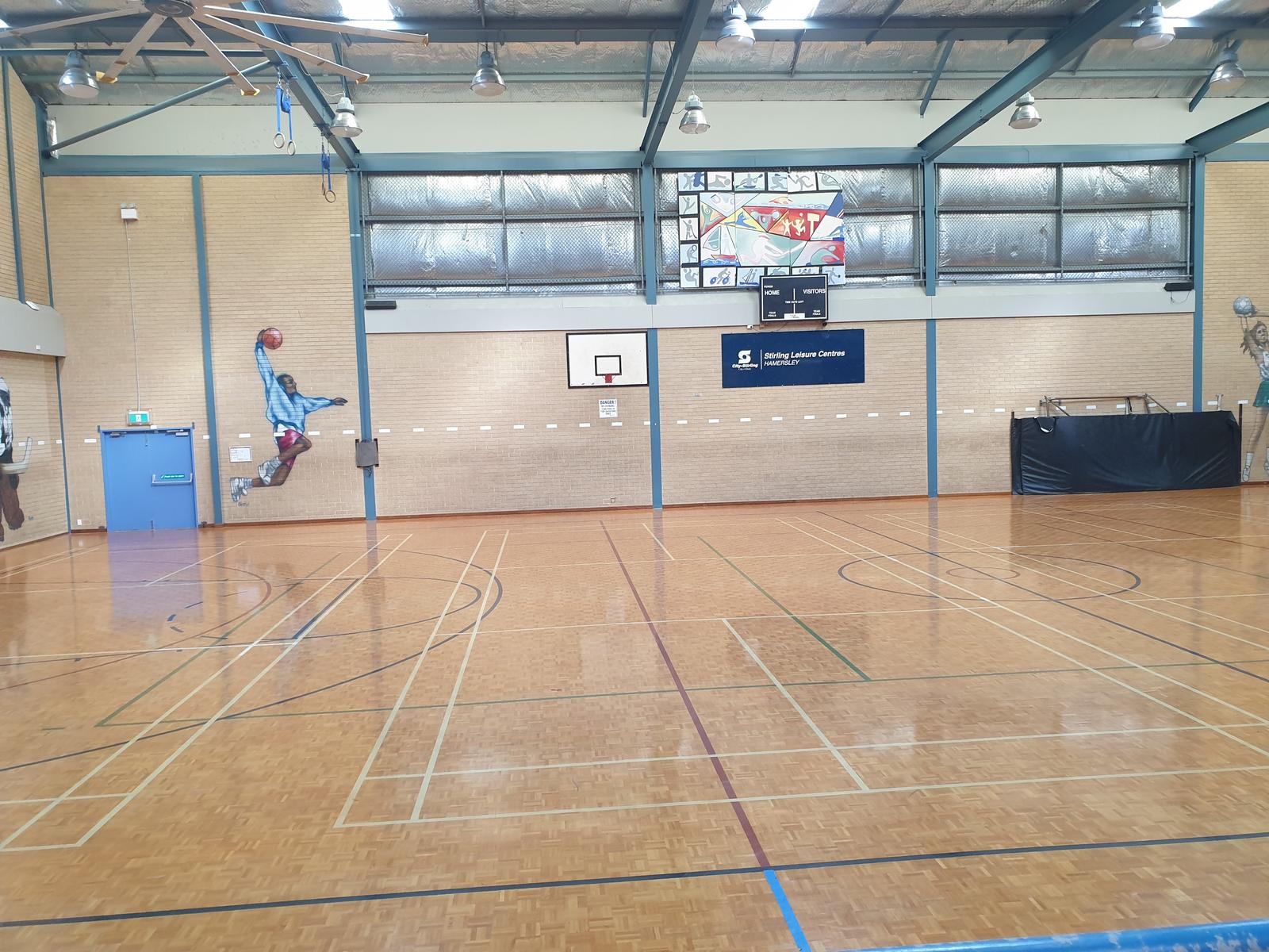 Indoor gymnasium with high ceilings and sports flooring