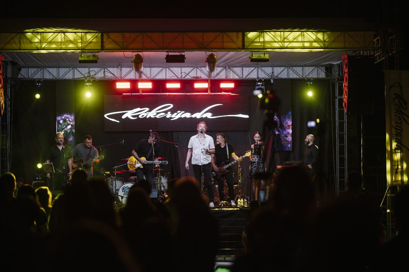 Outdoor music festival stage with large crowd