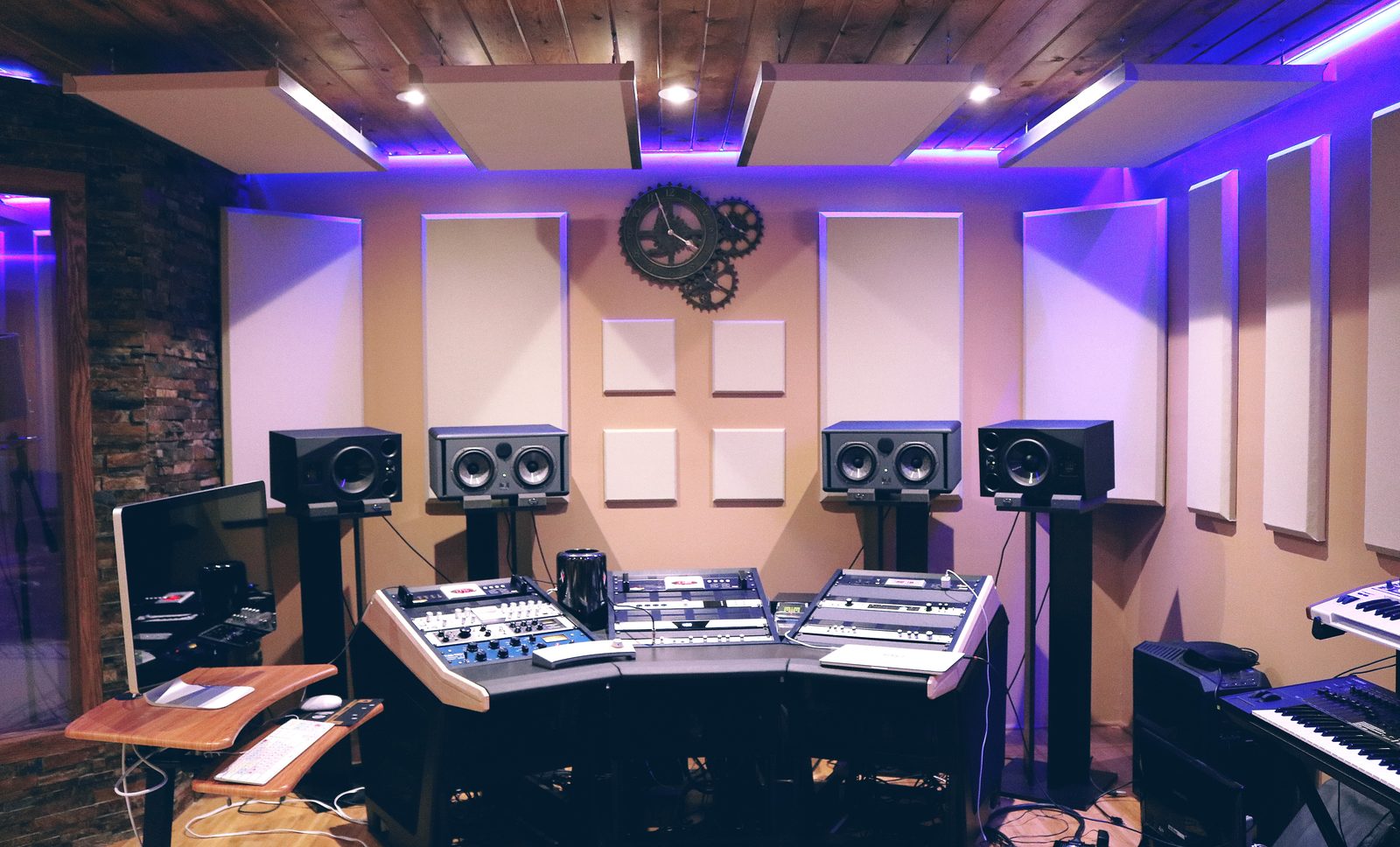 Recording studio control room with acoustic panels and mixing console