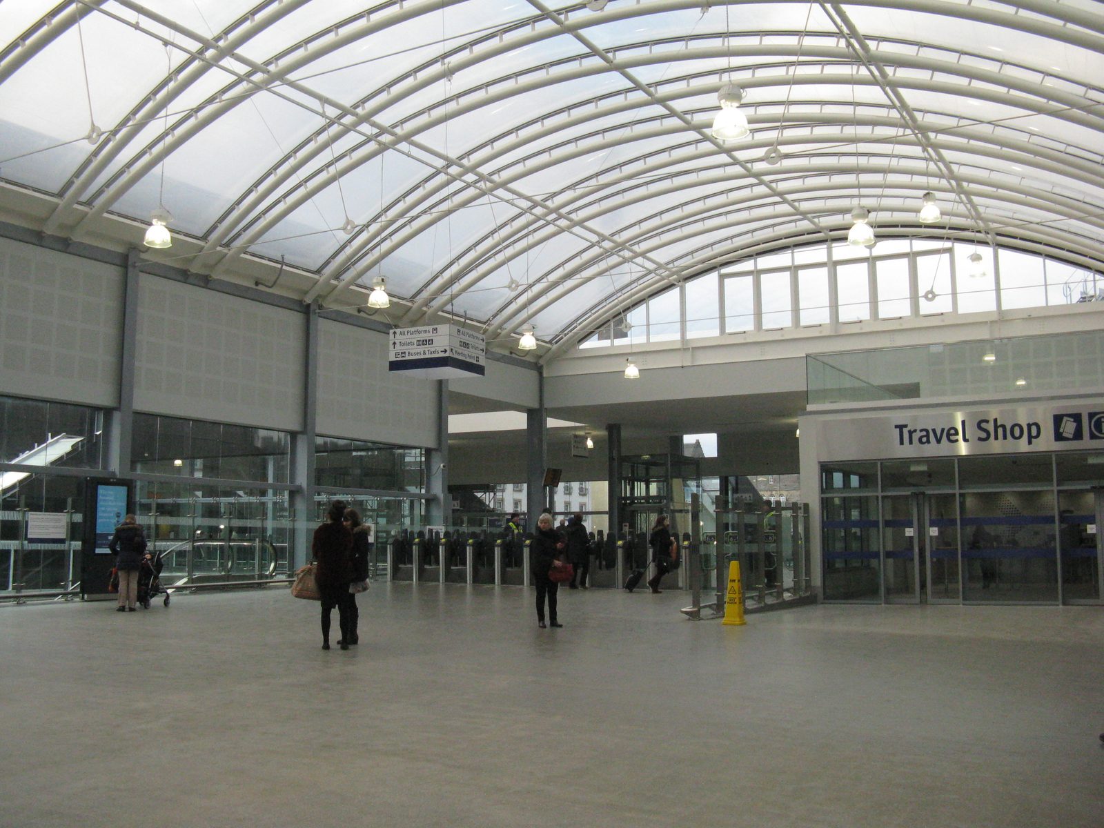 Train station concourse with travelers